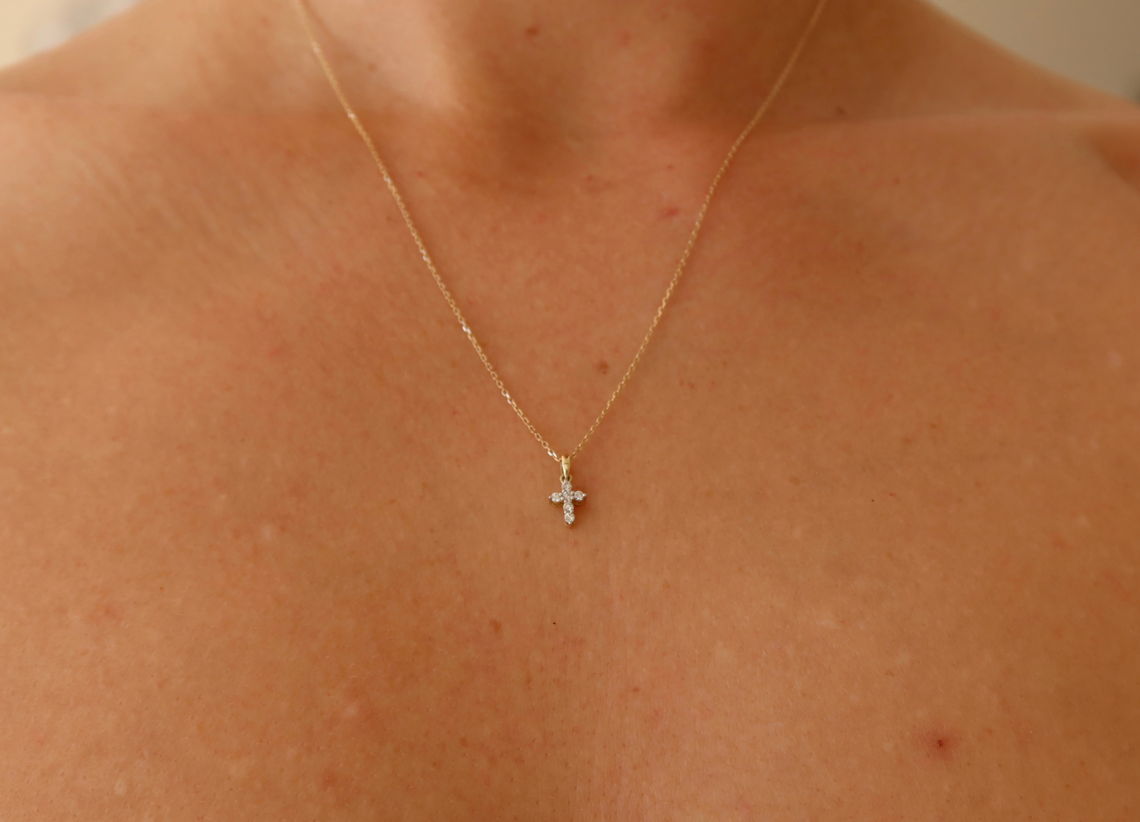 dainty 9 karat yellow gold oval link chain with mini diamond cross pendant
