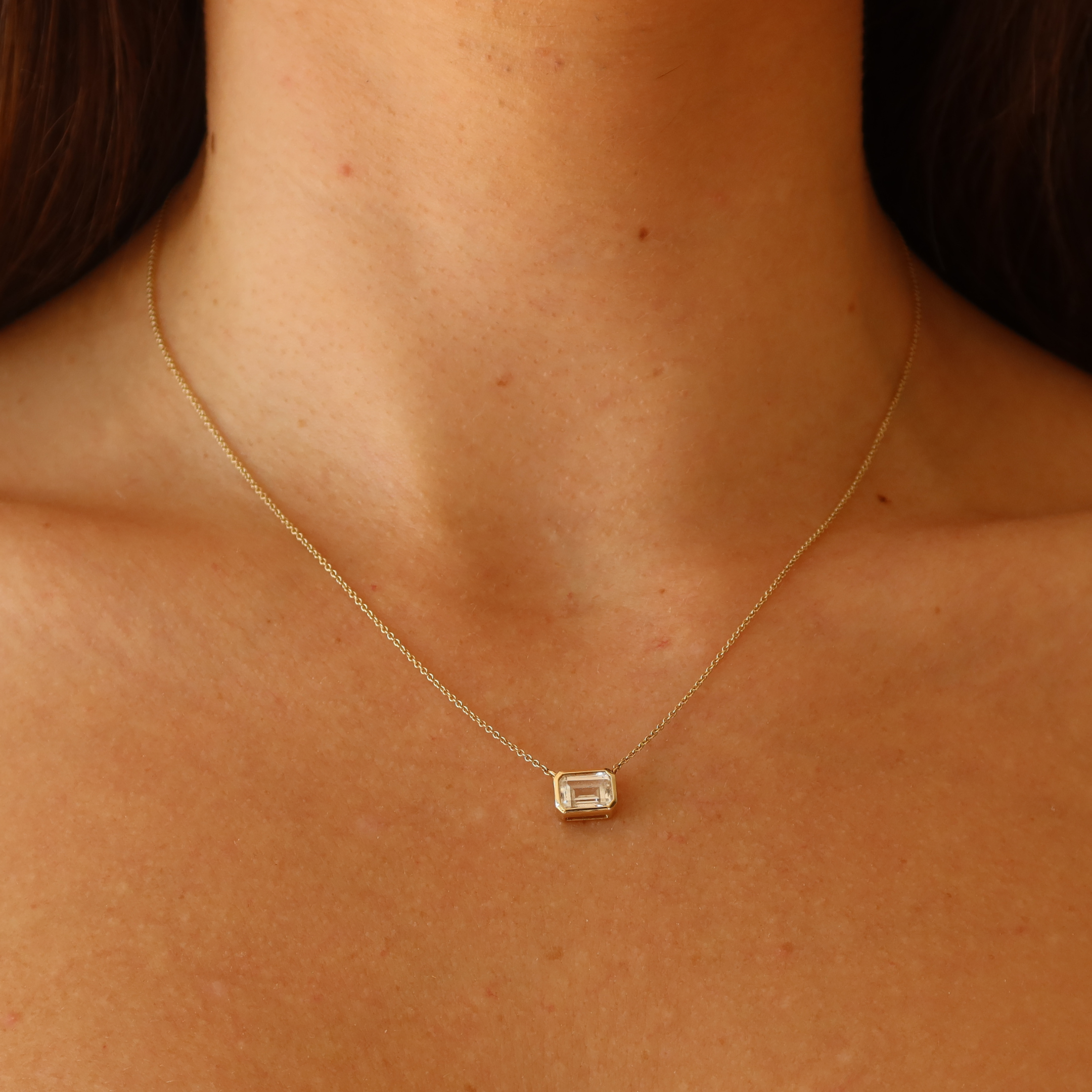 gold bezel necklace with white sapphire in 10 karat yellow gold