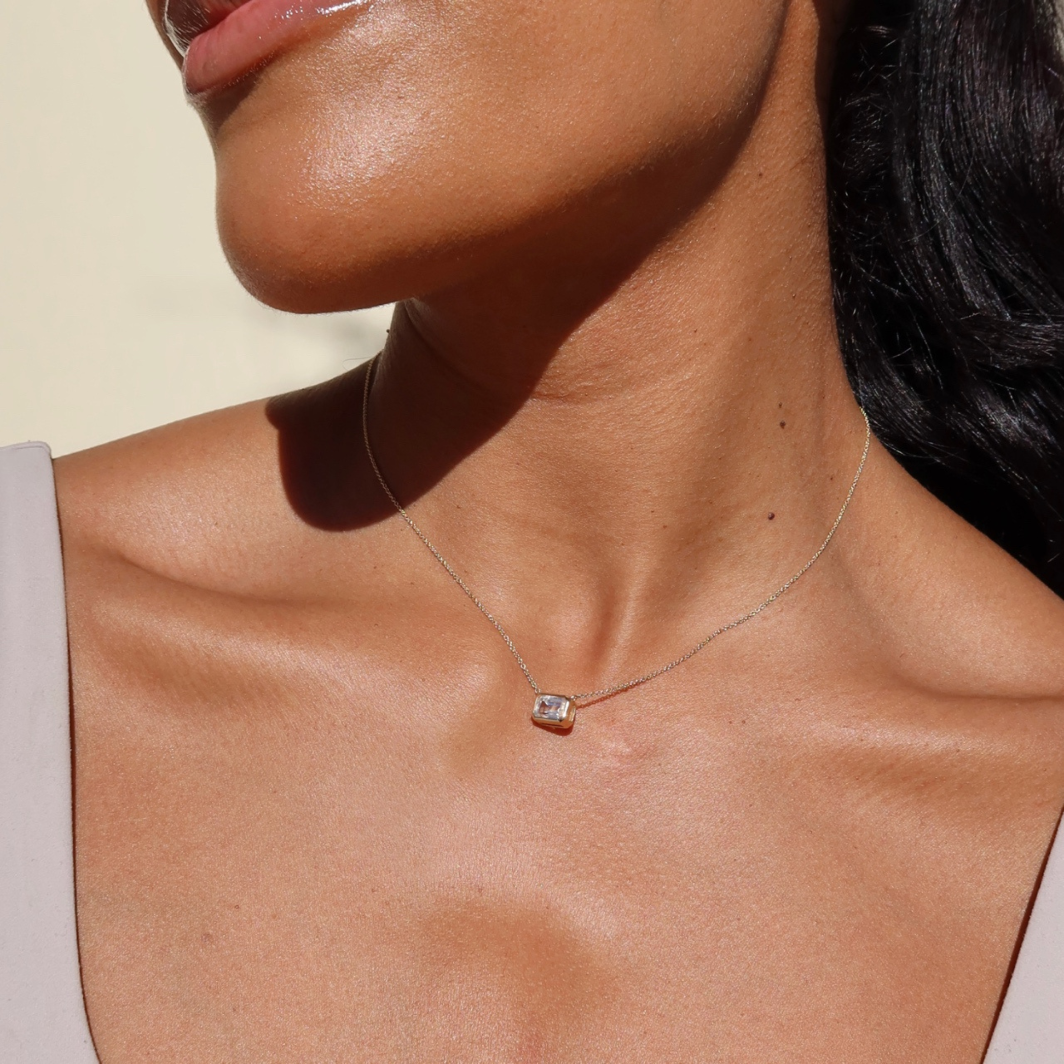 gold bezel necklace with white sapphire in 10 karat yellow gold