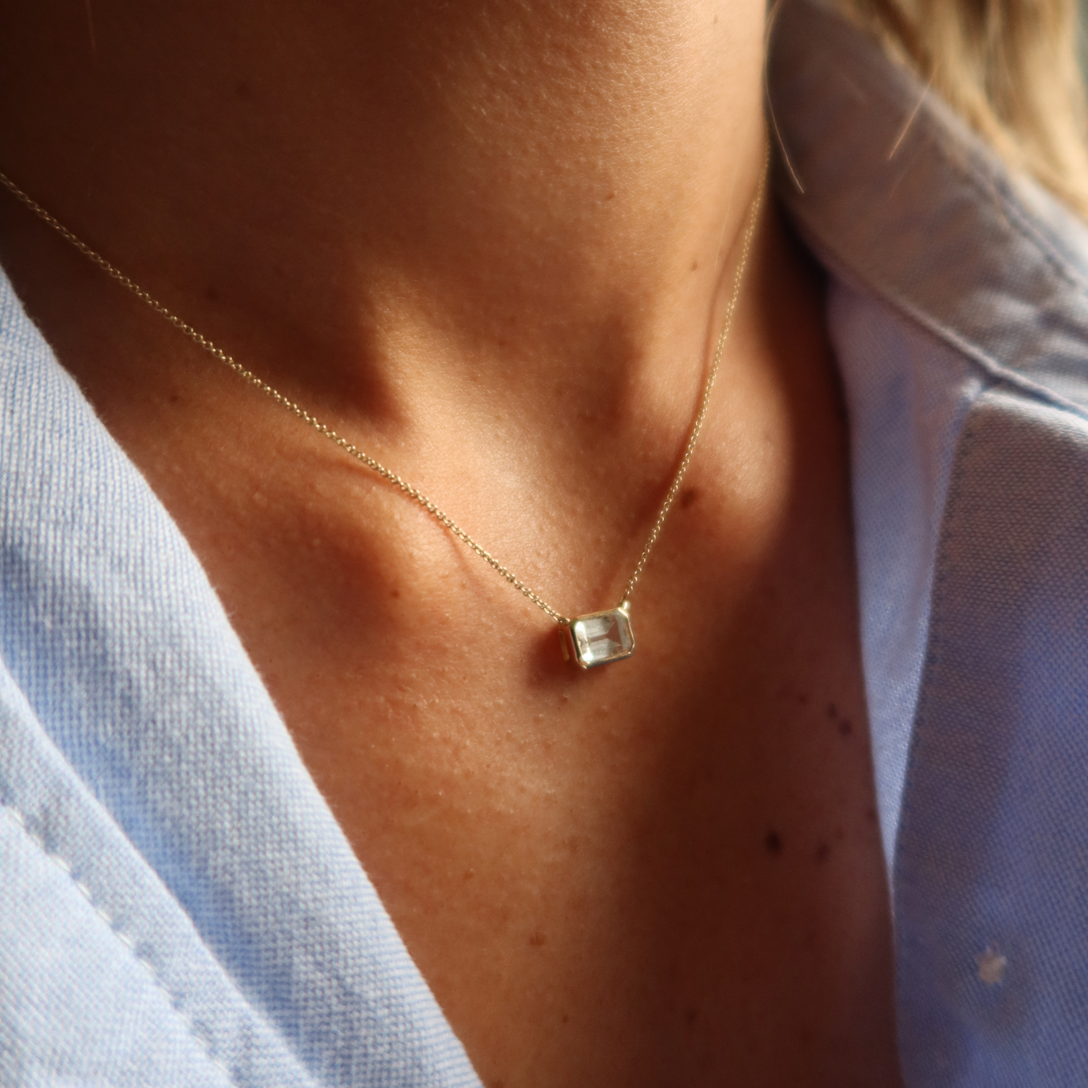 gold bezel necklace with white sapphire in 10 karat yellow gold